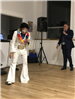Dressed up as Elvis and man in black suit singing